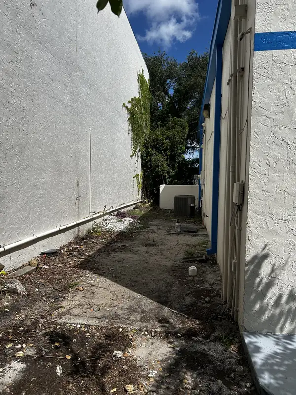 New pipe replaced and secured along the base of the exterior wall of a Sarasota building